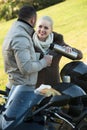 Couple posing near motor bike with sandwitches and coffee Royalty Free Stock Photo