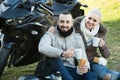 couple posing near motor bike with sandwitches and coffee Royalty Free Stock Photo