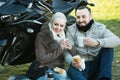 Couple posing near motor bike with sandwitches and coffee Royalty Free Stock Photo