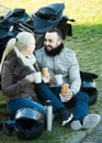 Couple posing near motor bike with sandwitches and coffee Royalty Free Stock Photo