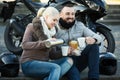 Couple posing near motor bike with sandwitches and coffee Royalty Free Stock Photo