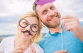 Couple posing with party props sky background. Photo booth props. Man with beard and woman having fun party. Add some