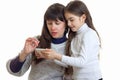 Couple of pother and daughter looking a photos on a mobile phone Royalty Free Stock Photo