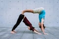 Couple practicing acro yoga outdoors. Acroyoga concept.