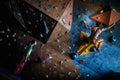 Couple practicing rock-climbing on a rock wall Royalty Free Stock Photo