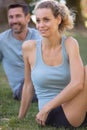 couple practicing yoga side twist stretch Royalty Free Stock Photo