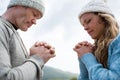 Couple praying with hands clasped Royalty Free Stock Photo