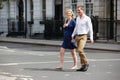 Couple With Pregnant Wife Crossing City Road Royalty Free Stock Photo