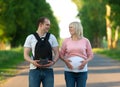 Couple With Pregnant Wife Crossing City Road Royalty Free Stock Photo