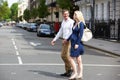 Couple With Pregnant Wife Crossing City Road Royalty Free Stock Photo