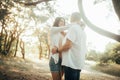 Couple with pregnant woman embrace at the forest Royalty Free Stock Photo
