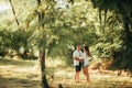 Couple with pregnant woman embraces at the forest Royalty Free Stock Photo