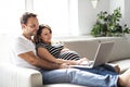 A Couple With Pregnant Woman Using Laptop Computer Together