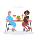 Couple pregnant women eating watermelon fresh fruit mix race girls discussing during meeting pregnancy and motherhood