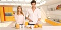 Couple prepairing healthy breakfast in modern interior
