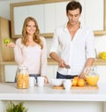 Couple prepairing healthy breakfast in modern interior