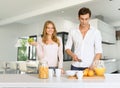 Couple prepairing healthy breakfast in modern interior