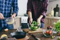 Couple preparing summer salad at home kitchen Healthy food