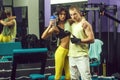 Muscular man and sexy girl at gym trainer with bottle Royalty Free Stock Photo