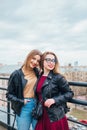 Couple of pretty women together in cityscape . Two joyful beautiful girls on roof . Beautiful city view Royalty Free Stock Photo