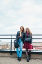 Couple of pretty women together in cityscape . Two joyful beautiful girls on roof . Beautiful city view Royalty Free Stock Photo