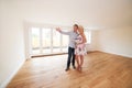 Couple With Property Details Looking Around New Home Royalty Free Stock Photo