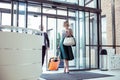 Couple of prosperous businessmen with luggage entering hotel Royalty Free Stock Photo