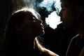 Couple puff smoke into face