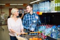 Couple purchasing mineral water Royalty Free Stock Photo