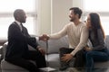 Couple purchasing realty feels satisfied shake hands thanking financial advisor