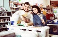 Couple purchasing tools for house improvements in paint supplies Royalty Free Stock Photo