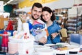 Couple purchasing tools for house improvements in paint supplies store Royalty Free Stock Photo