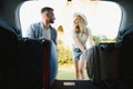 Couple putting suitcases in car trunk for a journey Royalty Free Stock Photo