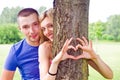 Couple is putting their hands on tree in a shape of heart Royalty Free Stock Photo