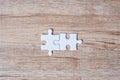 Couple puzzle pieces on wood table background. Business solutions, mission target, successful, goals, cooperation, partnership and Royalty Free Stock Photo