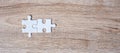 Couple puzzle pieces on wood table background. Business solutions, mission target, successful, goals, cooperation, partnership and Royalty Free Stock Photo