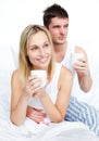 Couple in pyjamas drinking coffee in bed Royalty Free Stock Photo