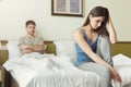 Couple after quarrel sitting in bed