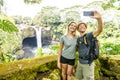 A couple at The Rainbow Falls, Hilo, Wailuku River State Park, Big Island, Hawaii Royalty Free Stock Photo