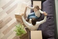 Couple raising hands celebrating moving into new home, top view Royalty Free Stock Photo