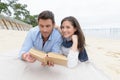 couple reading book on beach Royalty Free Stock Photo