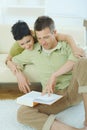 Couple reading book at home