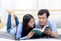 Couple reading a book together in bedroom on the morning. Royalty Free Stock Photo