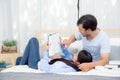 Couple reading a book together in bedroom on the morning. Royalty Free Stock Photo