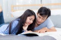 Couple reading a book together in bedroom on the morning. Royalty Free Stock Photo