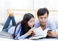 Couple reading a book together in bedroom on the morning. Royalty Free Stock Photo