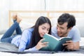 Couple reading a book together in bedroom on the morning with happiness Royalty Free Stock Photo