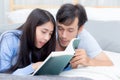 Couple reading a book together in bedroom on the morning with happiness. Royalty Free Stock Photo