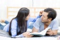 Couple reading a book together in bedroom on the morning with happy. Royalty Free Stock Photo