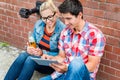 Couple reading city guide before making scooter tour in Berlin Royalty Free Stock Photo